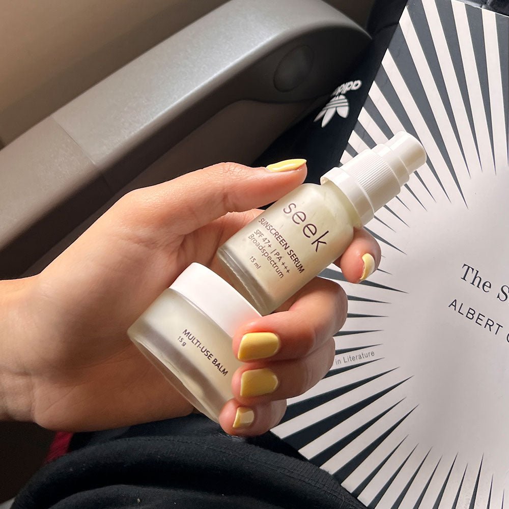 Seek Hydrate Shield Duo displayed with other travel skincare items