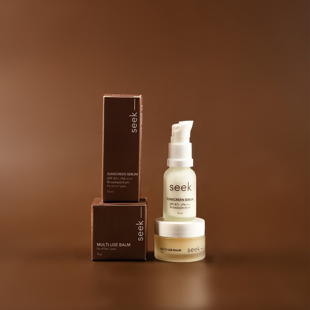 Mini SPF 47+ serum and multi-use balm laid flat with skincare essentials